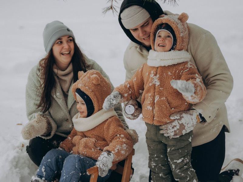Children sledding joyfully through a snowy winter day