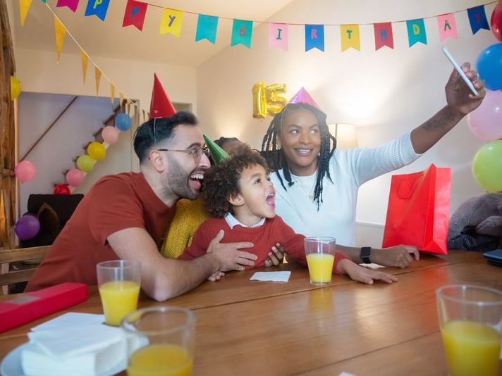 Family wearing party hats for a birthday celebration