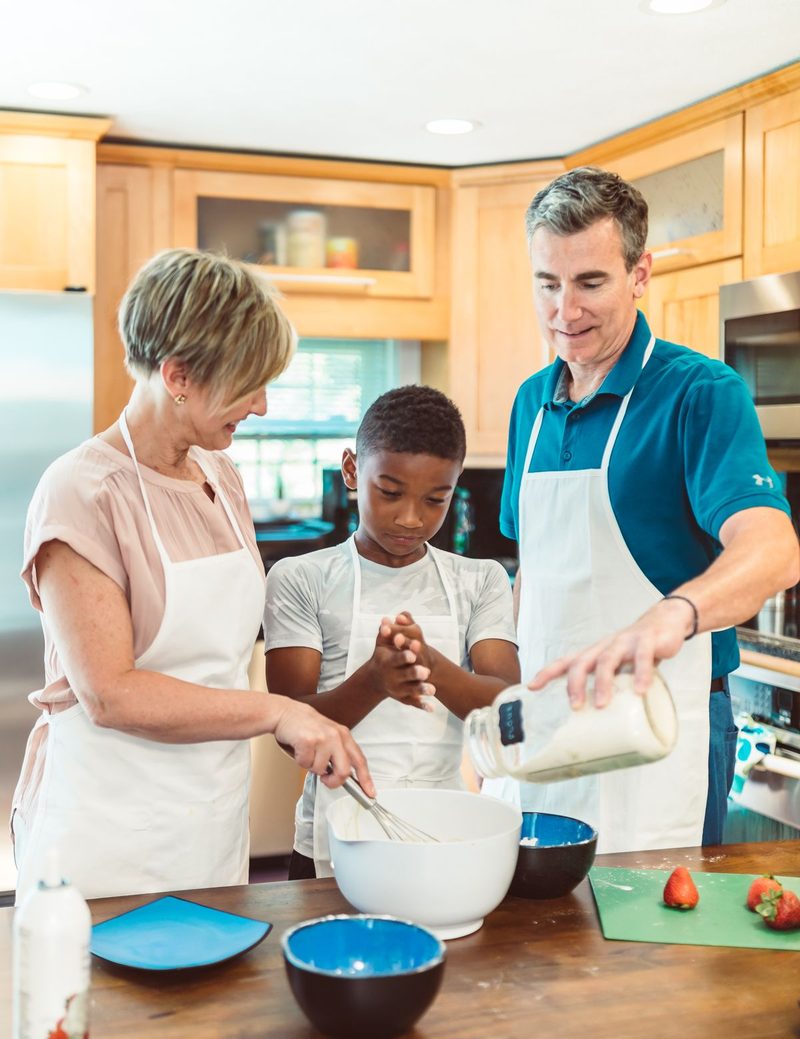 Parents and child baking cookies in a warm kitchen
